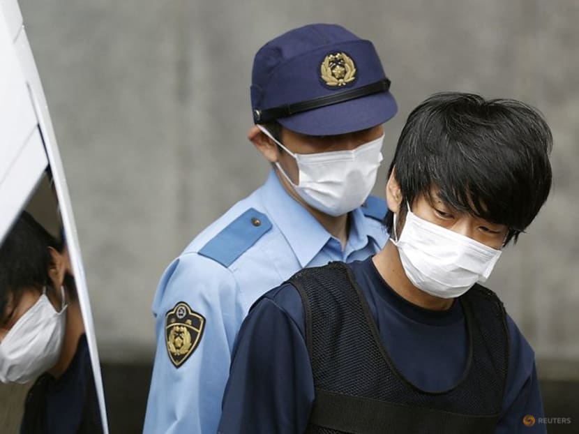 Tetsuya Yamagami, suspected of killing former Japanese Prime Minister Shinzo Abe, is escorted by a police officer as he is taken to prosecutors, at Nara-nishi police station in Nara, western Japan, in this photo taken by Kyodo July 10, 2022. Tetsuya Yamagami, suspected of killing former Japanese Prime Minister Shinzo Abe, is escorted by a police officer as he is taken to prosecutors, at Nara-nishi police station in Nara, western Japan, in this photo taken by Kyodo July 10, 2022.