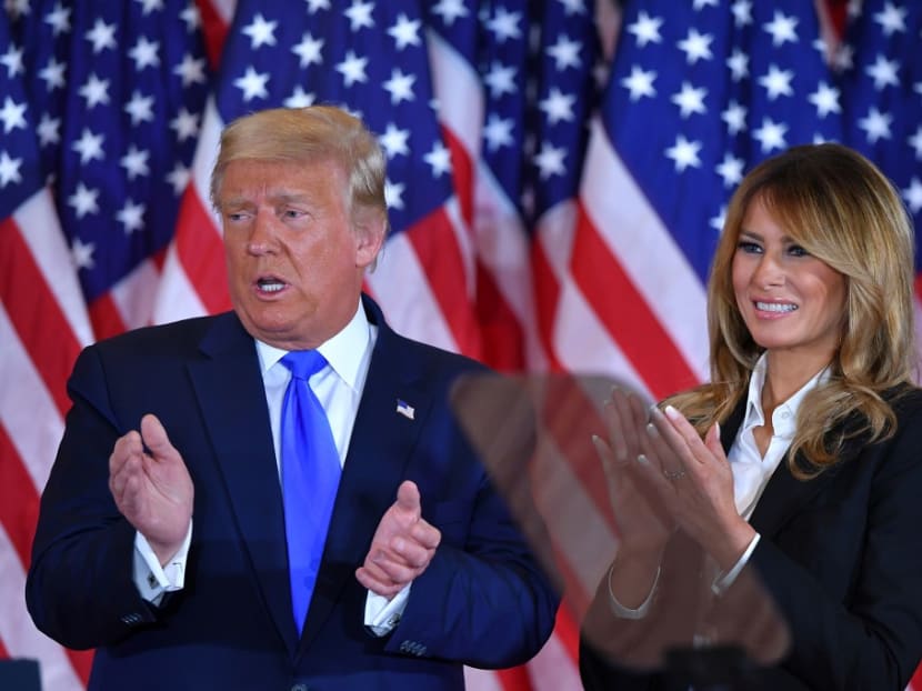 US president Donald Trump claps alongside US First Lady Melania Trump after speaking during election night in the East Room of the White House in Washington, DC, early on Nov 4, 2020.