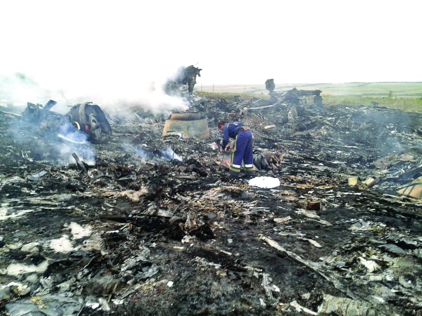 An Emergencies Ministry member at the site of a Malaysia Airlines Boeing 777 plane crash in the settlement of Grabovo in the Donetsk region yesterday. Photo: REUTERS