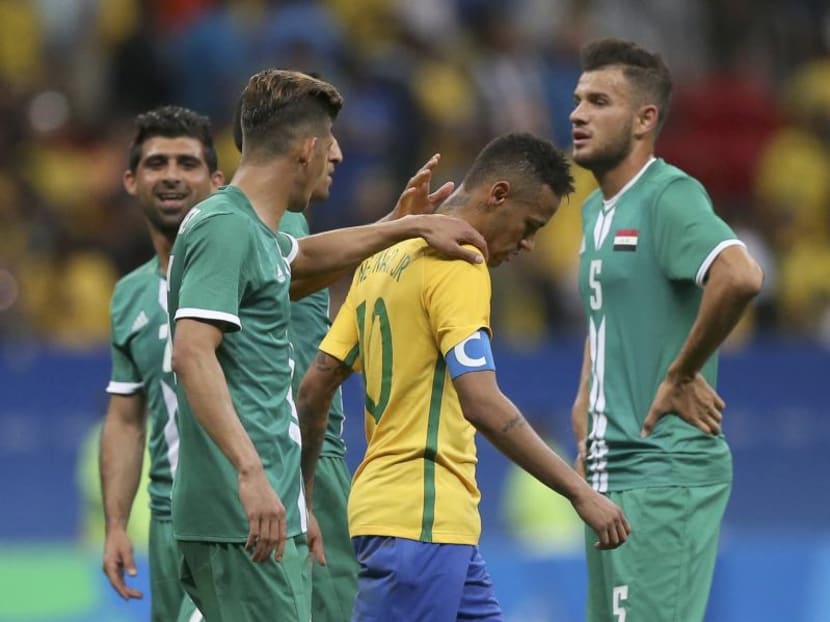 Brazil's Neymar walking away in dejection and receiving consolatory pats on the back from Iraq players following his team's 0-0 draw. Photo: Reuters
