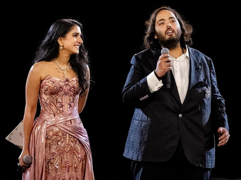 This handout photograph taken and released by Reliance on March 1, 2024, shows director at Reliance's new energy business and Reliance Foundation Anant Ambani (R), son of billionaire tycoon Mukesh Ambani, with his fiancée Radhika Merchant, the daughter of wealthy pharmaceutical moguls. This handout photograph taken and released by Reliance on March 1, 2024, shows director at Reliance's new energy business and Reliance Foundation Anant Ambani (R), son of billionaire tycoon Mukesh Ambani, with his fiancée Radhika Merchant, the daughter of wealthy pharmaceutical moguls.