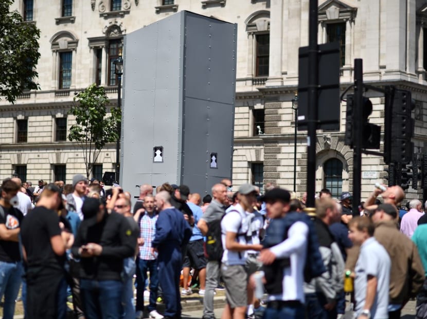 Members of far right groups gather around the boarded-up statue of Winston Churchill in Parliament Square in central London on June 13, 2020.