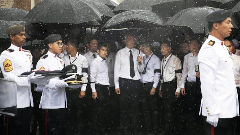 Crowds brave torrential downpour as Othman Wok is laid to rest