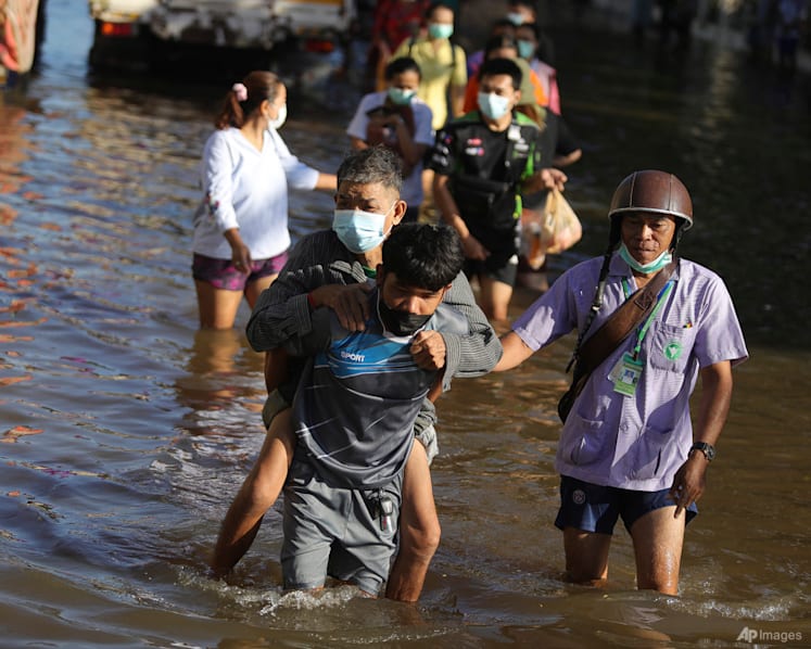 Thai rescuers battle floodwaters to reach dozens stranded in homes