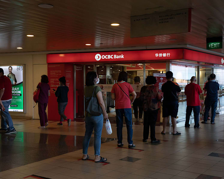 Seeking good luck, some Singaporeans deposit cash in person on Li Chun, others transfer money online