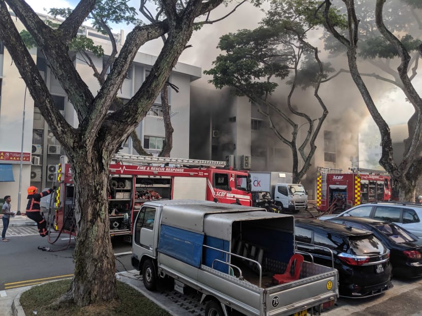 Firefighters from the Singapore Civil Defence Force were seen trying to put out the blaze at the four-storey building, which has a mix of residential units and shops.