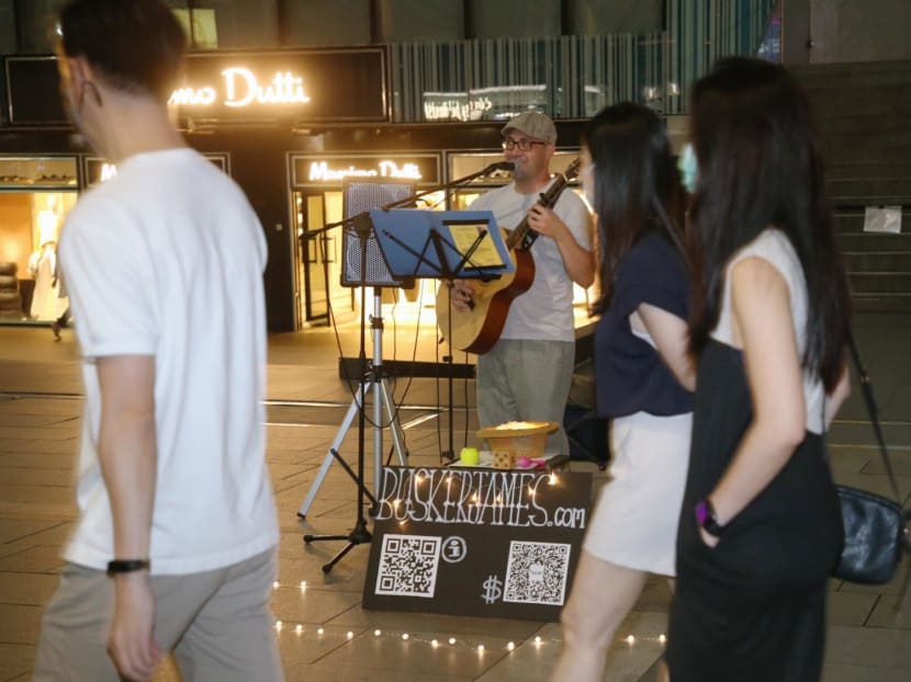 A busker performing outside Liat Towers on Orchard Road. A busker performing outside Liat Towers on Orchard Road.