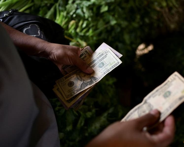 Dollar scarcity in Venezuela forces small firms to raise prices, turn to crypto