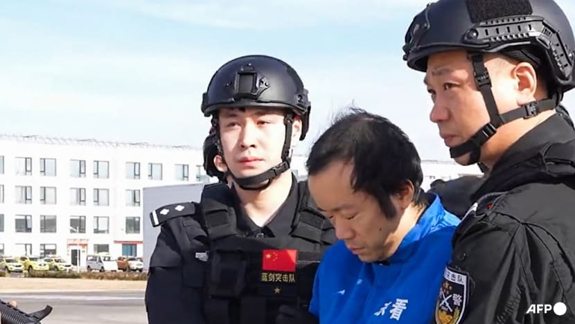 China TV shows alleged scam kingpin Chen Zhi handcuffed and hooded after arrest and extradition from Cambodia