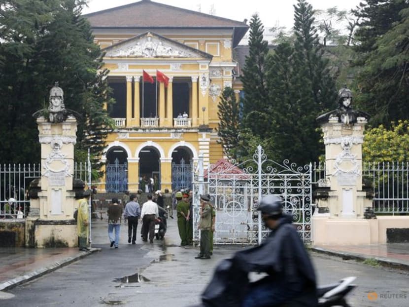 A man rides a motorcycle past the People's Court in Ho Chi Minh city on Jan 20, 2010.