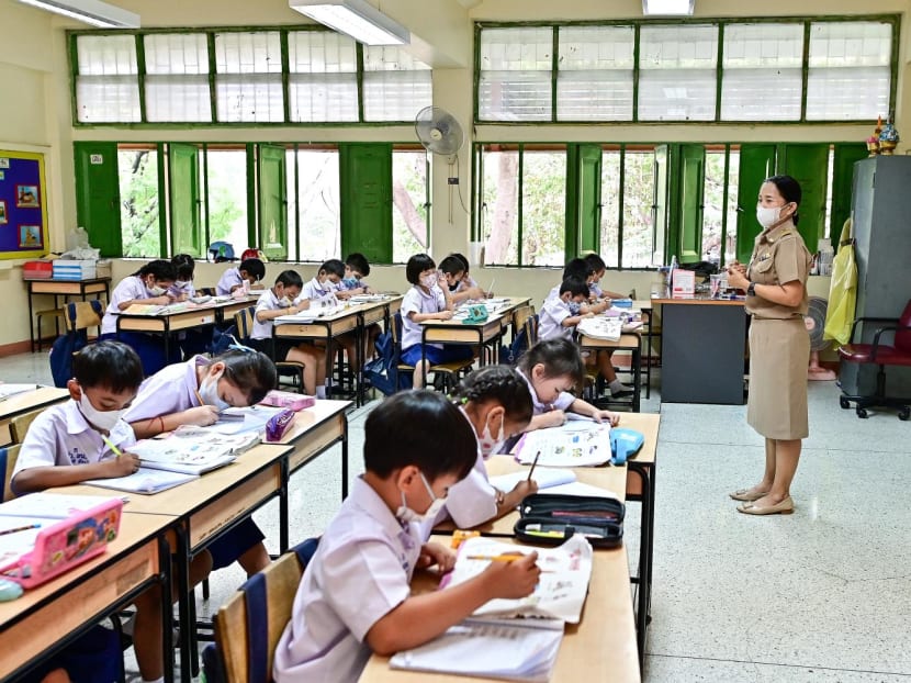 This photo taken on Jan 22, 2024 shows pupils wearing face masks inside a classroom with open windows at Suan Lumphini School in Bangkok.