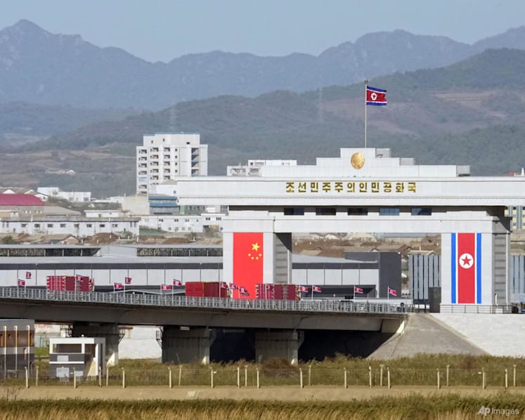 Trucks line up as long-delayed China-North Korea bridge officially opens