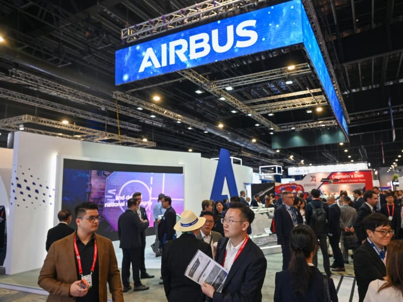 Visitors walk past the Airbus booth during the Singapore Airshow in Singapore on Feb 21, 2024.