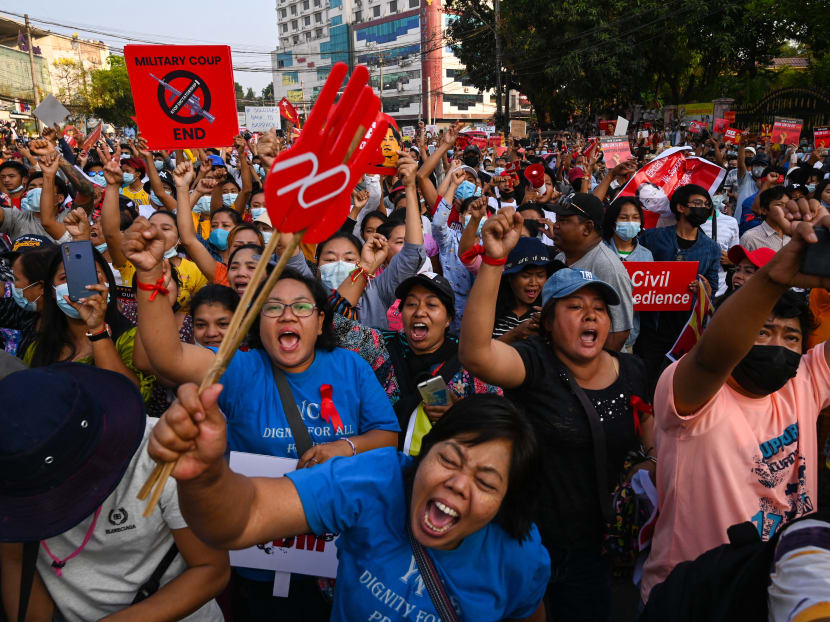 Protesters take part in a demonstration against the military coup in front of the National League for Democracy (NLD) office in Yangon on February 15, 2021.