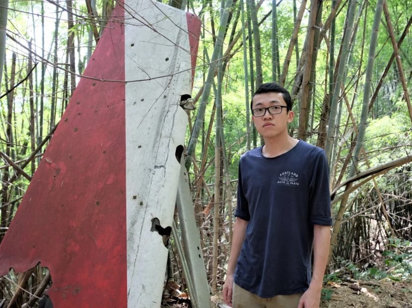 Mr Felix Wong, a Hong Kong-born Canadian, in a jungle in Suphanburi, Thailand, beside a vertical stabiliser that belonged to the Lauda Air Flight 004 plane that crashed on its way from Hong Kong to Vienna in 1991. His aunt was among the 223 people killed.