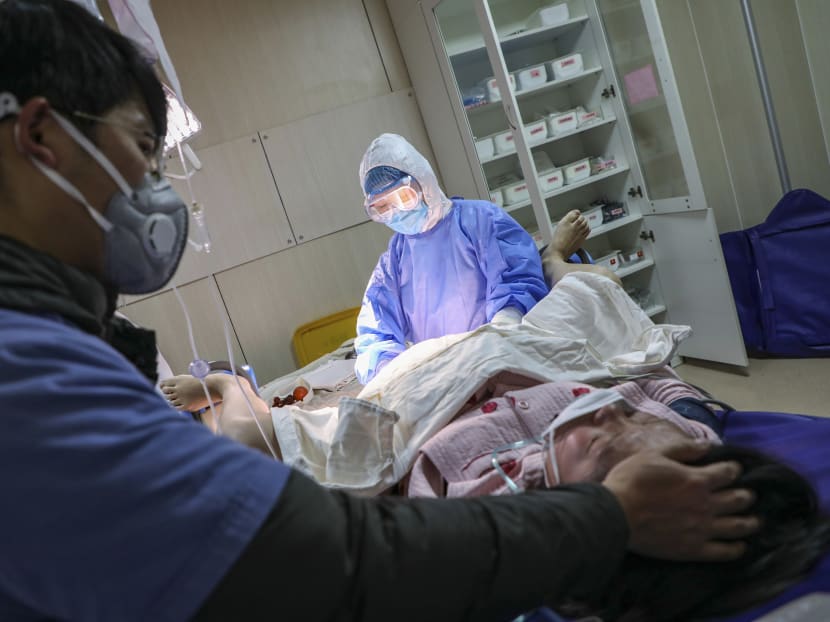 A pregnant woman wearing a protective facemask gives birth at a hospital in Wuhan in China's central Hubei province.