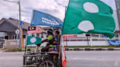 Man-on-motorcyle-with-parti-islam-se-malaysia-and-perikatan-nasional-flag-in-terengganu