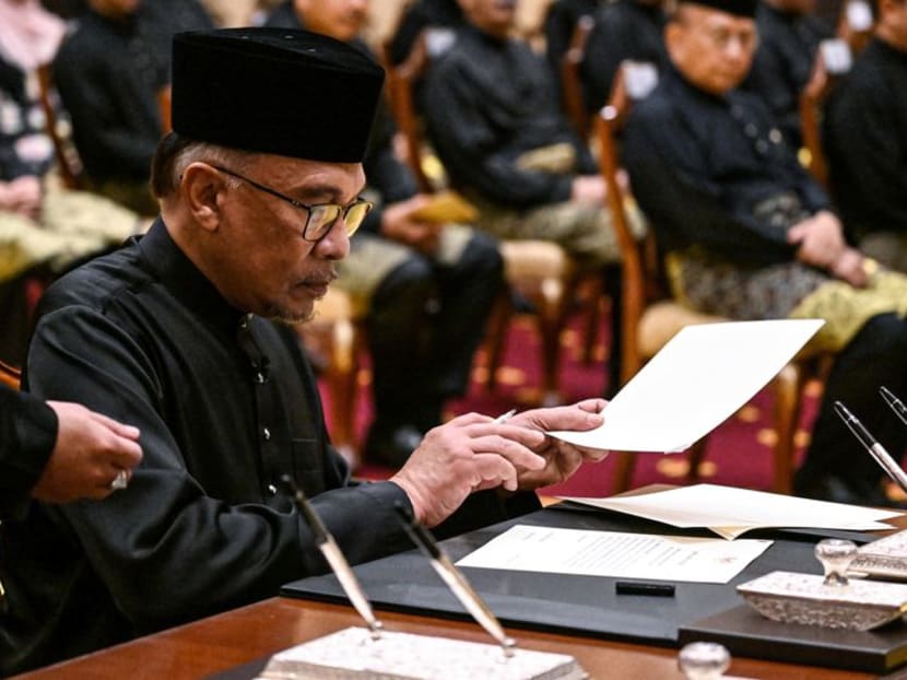Malaysia's newly appointed Prime Minister Anwar Ibrahim signs documents after taking the oath during the swearing-in ceremony at the National Palace in Kuala Lumpur, Malaysia on November 24, 2022. Mohd Rasfan/Pool via REUTERS Malaysia's newly appointed Prime Minister Anwar Ibrahim signs documents after taking the oath during the swearing-in ceremony at the National Palace in Kuala Lumpur, Malaysia on November 24, 2022. Mohd Rasfan/Pool via REUTERS