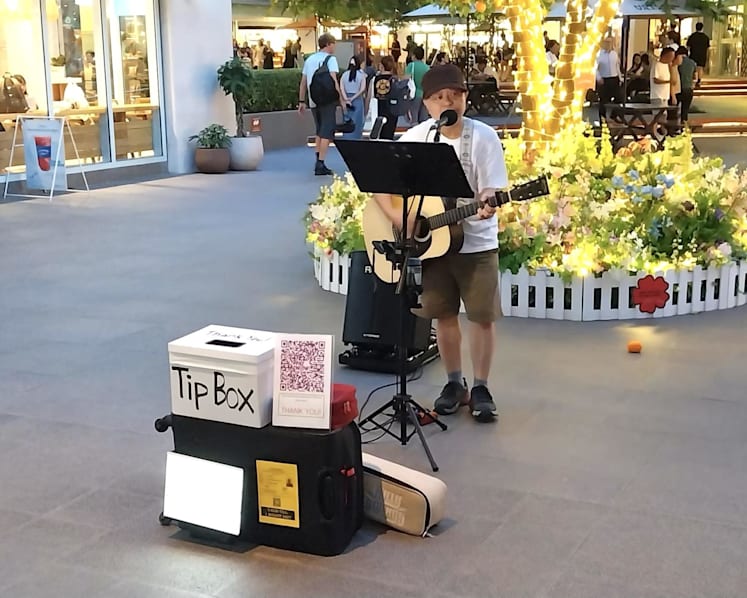 What’s it like to be a busker in Singapore? Chicken nuggets, a bucket list dream and performing on the streets