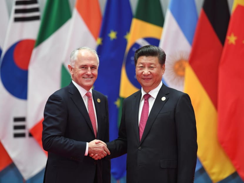 Australia’s Prime Minister Malcolm Turnbull shakes hands with China’s President Xi Jinping (R) before the G20 leaders’ family photo in Hangzhou last year. China accused Australia of hysteria and paranoia on Wednesday (Dec 6) after Prime Minister Malcolm Turnbull vowed to ban foreign political donations in a move to curb external influence on its domestic politics. Photo: AFP