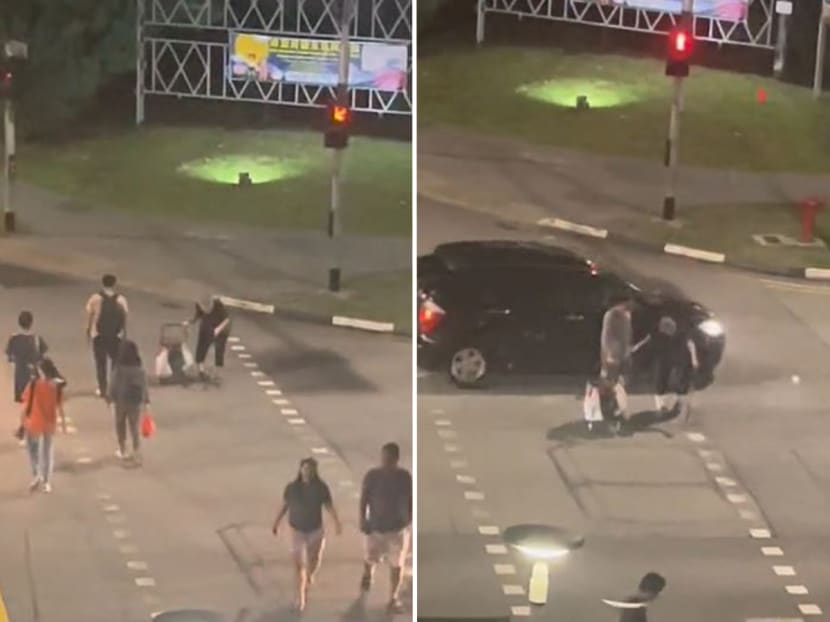 The good Samaritan assists the elderly woman across the road despite the danger of oncoming traffic.
