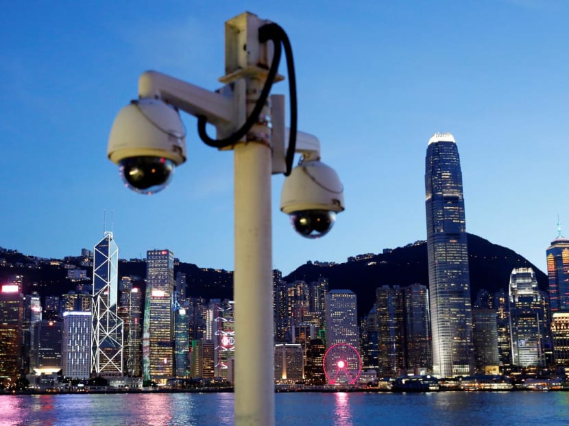 A pair of surveillance cameras are seen along the Tsim Sha Tsui waterfront as skyline buildings stand across Victoria Harbor in Hong Kong, China on July 28, 2020. A pair of surveillance cameras are seen along the Tsim Sha Tsui waterfront as skyline buildings stand across Victoria Harbor in Hong Kong, China on July 28, 2020.