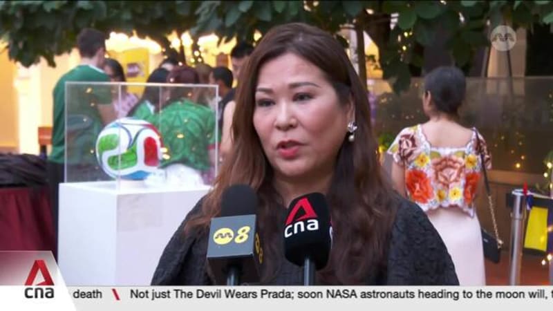 Football fans in Singapore celebrate opener with embassies of host cities