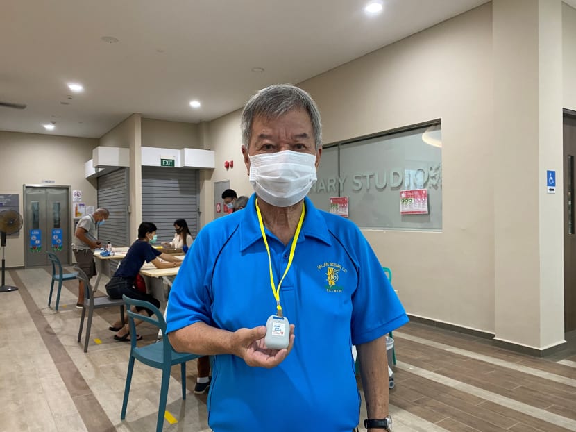 Mr Hong Kim Siong poses with his TraceTogether token at Jalan Besar CC after collecting it.