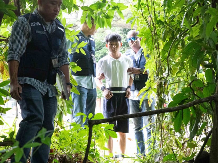 Wu Jinxing (second from right) taken to one of the sites along the Rail Corridor where an alleged loot was found by the police. Wu Jinxing (second from right) taken to one of the sites along the Rail Corridor where an alleged loot was found by the police.