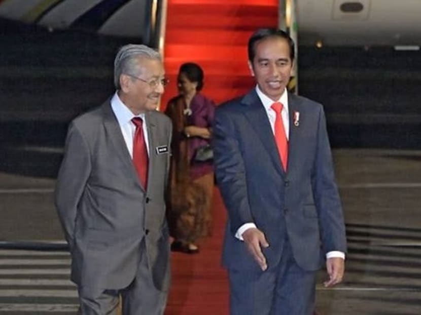 Indonesian president Joko Widodo welcoming Malaysian prime minister Tun Dr Mahathir Mohamad, as the latter arrived in Indonesia on Thursday (June 28).