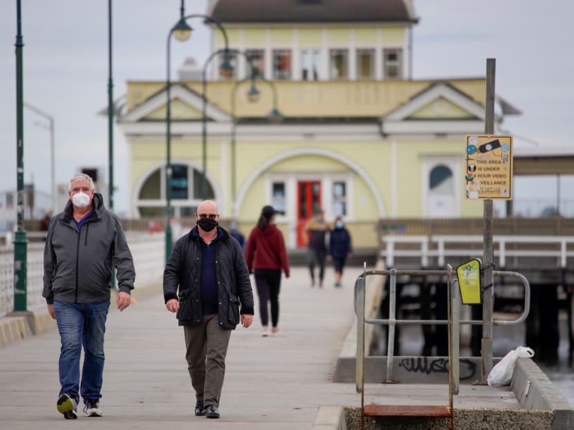 Walkers wear protective face masks at St Kilda pier in Melbourne after it became the first city in Australia to enforce mask-wearing in public as part of efforts to curb a resurgence of Covid-19 on Thursday, July 23, 2020. Walkers wear protective face masks at St Kilda pier in Melbourne after it became the first city in Australia to enforce mask-wearing in public as part of efforts to curb a resurgence of Covid-19 on Thursday, July 23, 2020.