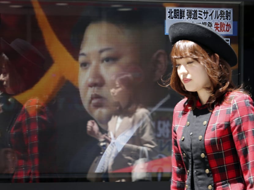 People walk past a TV news showing an image of North Korean leader Kim Jong Un while reporting North Korea's rocket launch, in Tokyo, Saturday, April 29, 2017. Photo: AP