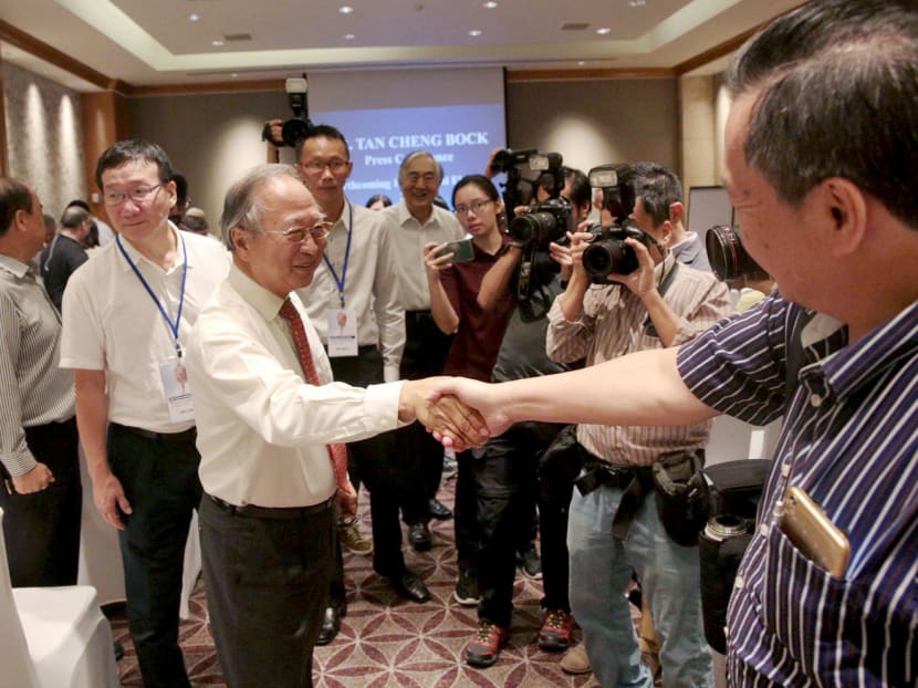 Dr Tan (left) greeting Mr Tan Kin Lian during a press conference yesterday. Dr Tan argued that there had been only four terms since the EP scheme was introduced and the presidential polls in September should be an 

open election. Photo: Jason Quah