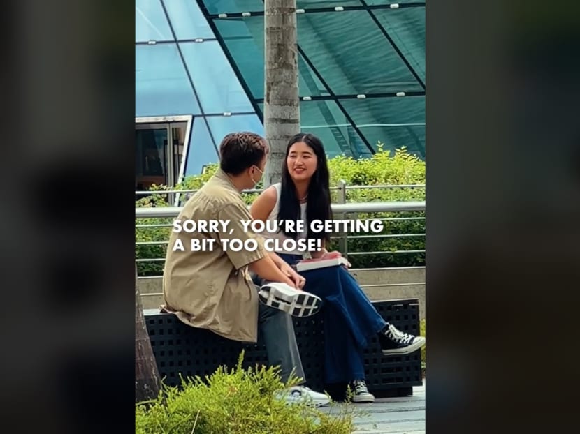A screenshot from a "social experiment" of a staged incident of a woman being harassed by a man near Marina Bay Sands. A screenshot from a "social experiment" of a staged incident of a woman being harassed by a man near Marina Bay Sands.