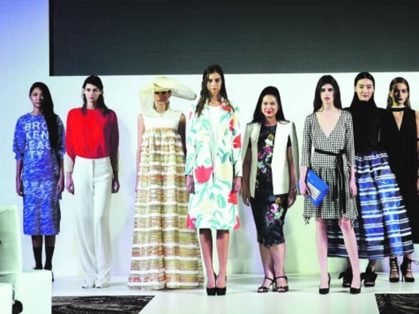 Chairman of Singapore Fashion Week Tjin Lee with some of the models at the 2015 edition. Photo: Singapore Fashion Week