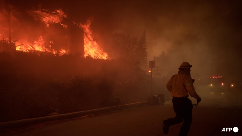 Wildfire sparks panicked evacuations in Los Angeles suburb