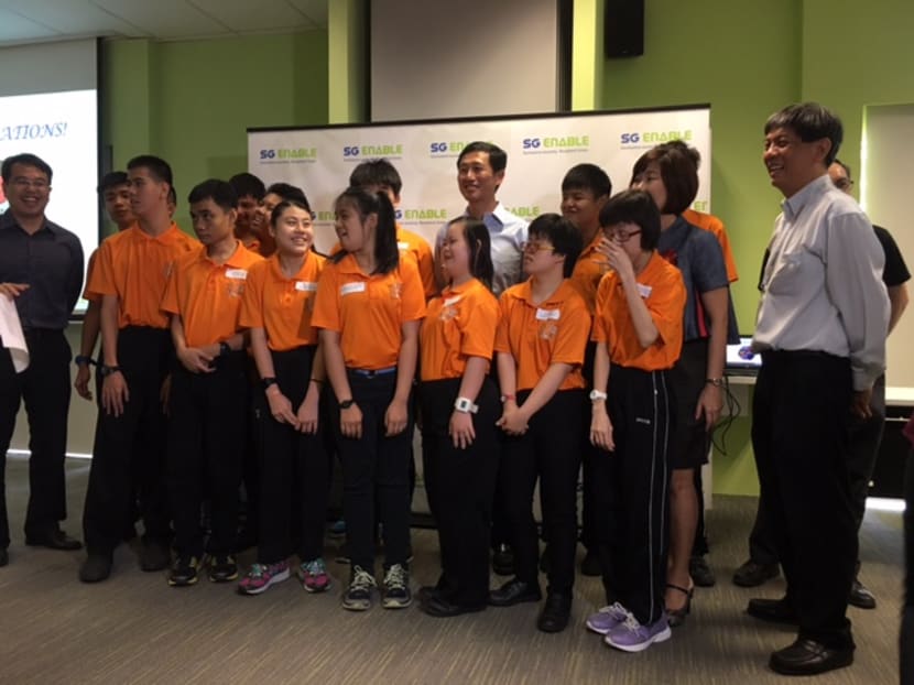 Participants of SG Enable’s school-to-work transition programme (dressed in orange) had a get-together on Nov 30, 2016, at the Enabling Village. At the event, Minister for Education (Higher Education and Skills) Ong Ye Kung (centre) announced the expanded use of the Post-Secondary Education Account. Photo: Tan Weizhen/TODAY