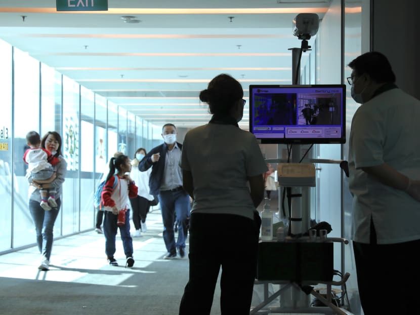 Border screeners monitor a thermal scanner set up at Changi Airport Terminal 3 to screen passengers coming in on a flight from Hangzhou, China on Jan 22, 2020. Changi Airport has set up more than 35 scanners across all four terminals to screen passengers coming in from over 430 flights from China each week. Border screeners monitor a thermal scanner set up at Changi Airport Terminal 3 to screen passengers coming in on a flight from Hangzhou, China on Jan 22, 2020. Changi Airport has set up more than 35 scanners across all four terminals to screen passengers coming in from over 430 flights from China each week.