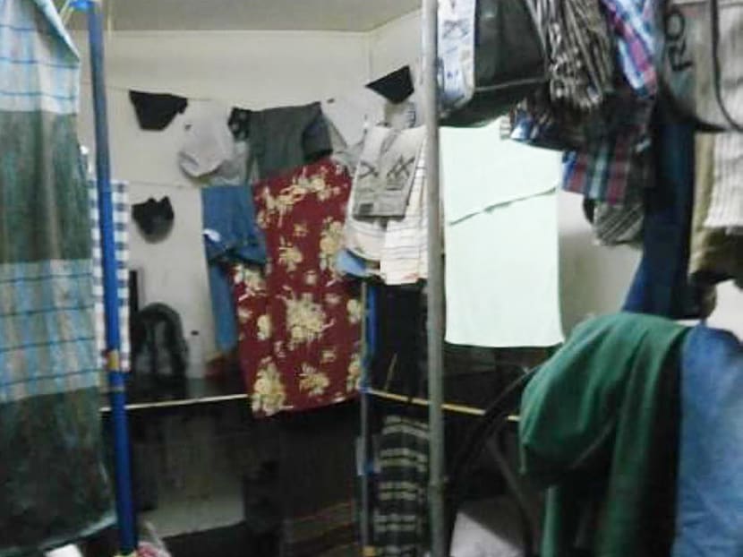 Workers had to hang wet laundry where they sleep because a construction firm crammed them into houses that were not approved as dormitories.