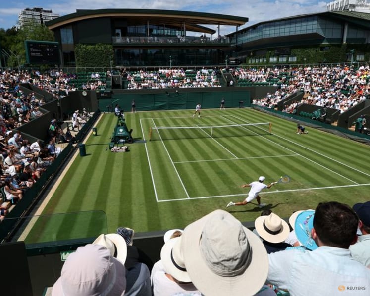 Honorary Brit De Minaur eases into second round