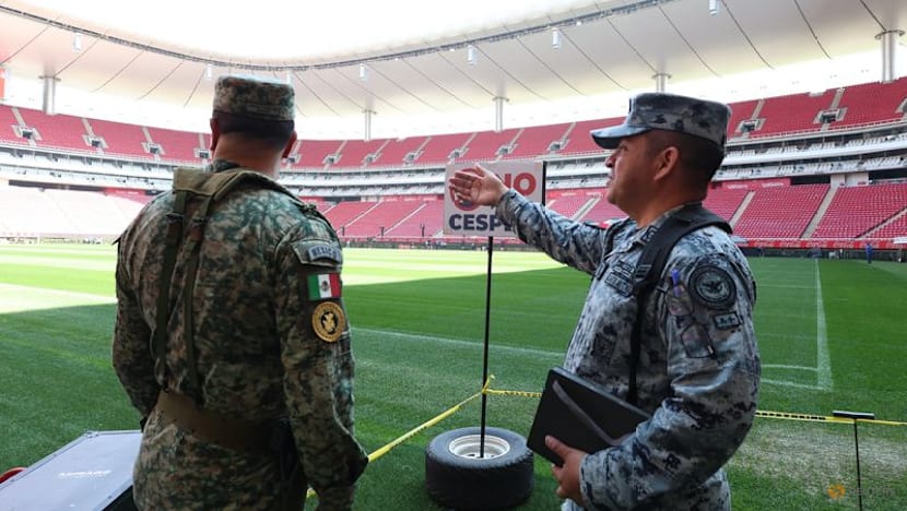 Mexican fans enjoy a brief respite from violence as they gaze at World Cup trophy