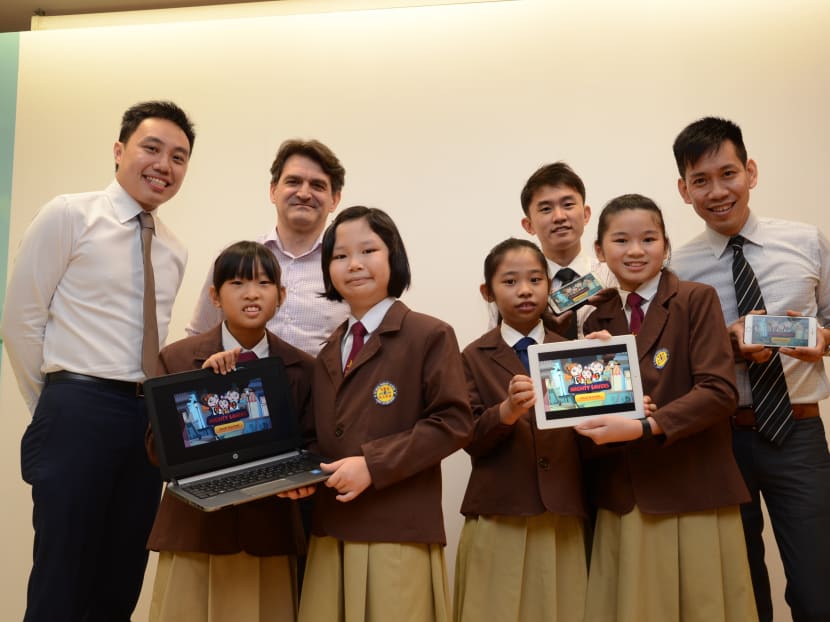 The students from Yu Neng Primary School, (front row, from left to right) Seng Hui Ting, Cheryl Ho, Charmaine Thoi and Toh Yi Xuan, with their OCBC Bank mentors, (back row, from left to right) Mr Malie Foo, Assistant Vice President, Group Operations & Technology (O&T), Mr Bojan Blecic, Senior Vice President, Customer Experience, Mr Ricky Boon, Manager, Group O&T and their teacher, Mr Yok Joon Meng. Photo: OCBC Bank