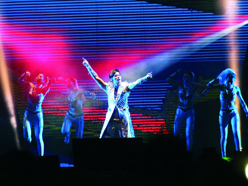 Jay Chou in a shiny, sleeveless trenchcoat at 
his Opus 2 World Tour concert 
in Singapore in 2014. TODAY file photo