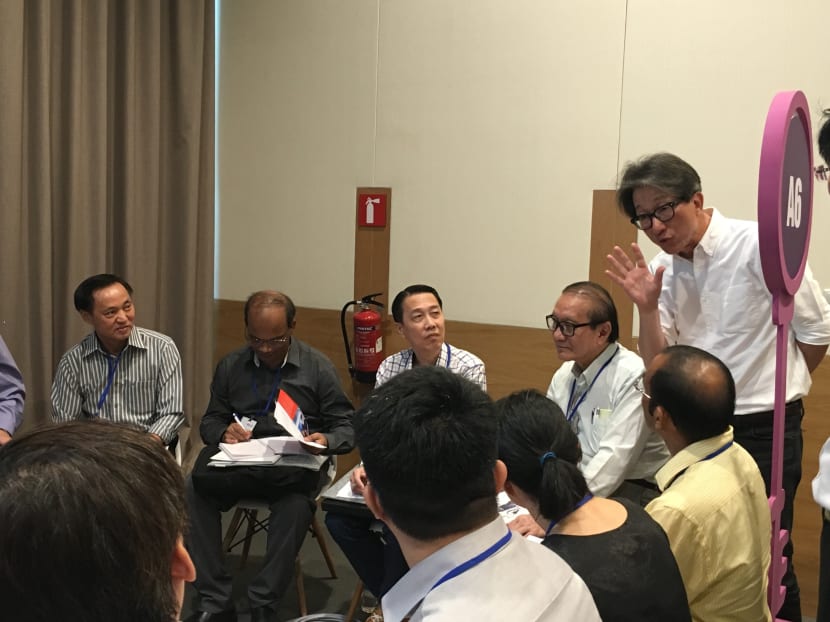 Manpower Minister Lim Swee Say (far right) interacting with employers and job seekers at the inaugural Adapt and Grow ICT Career Fair on May 4, 2016. Photo: Louisa Tang/TODAY