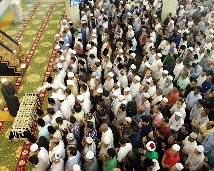 Crowds brave torrential downpour as Othman Wok is laid to rest