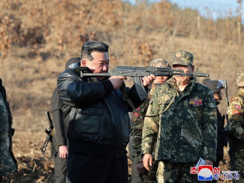 North Korean leader Kim Jong Un holds a firearm while he inspects field training of troops at a major military operations base in the western region of the country, as he ordered heightened readiness for war, KCNA news agency reported, in North Korea, in this picture released on March 7, 2024 by the Korean Central News Agency.