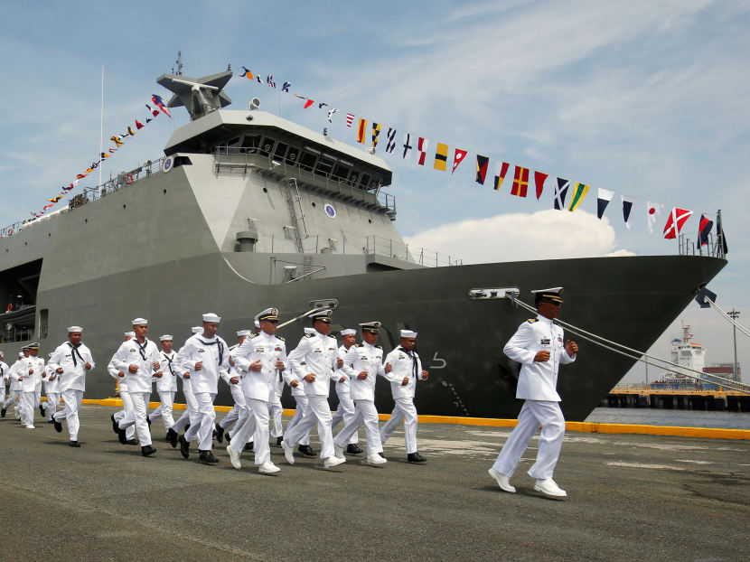 Philippine Navy personnel jog past a Strategic Sealift Vessel BRP Tarlac LD601 vessel. Photo: Reuters Philippine Navy personnel jog past a Strategic Sealift Vessel BRP Tarlac LD601 vessel. Photo: Reuters