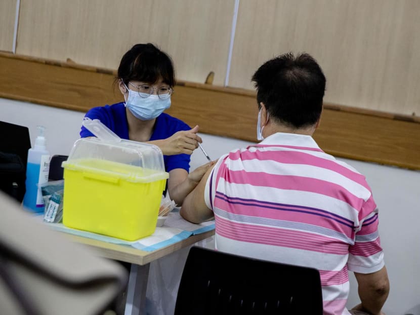 People getting their bivalent Covid-19 vaccine administered by a mobile vaccination team at Hong Kah Community Club on Dec 12, 2022. 