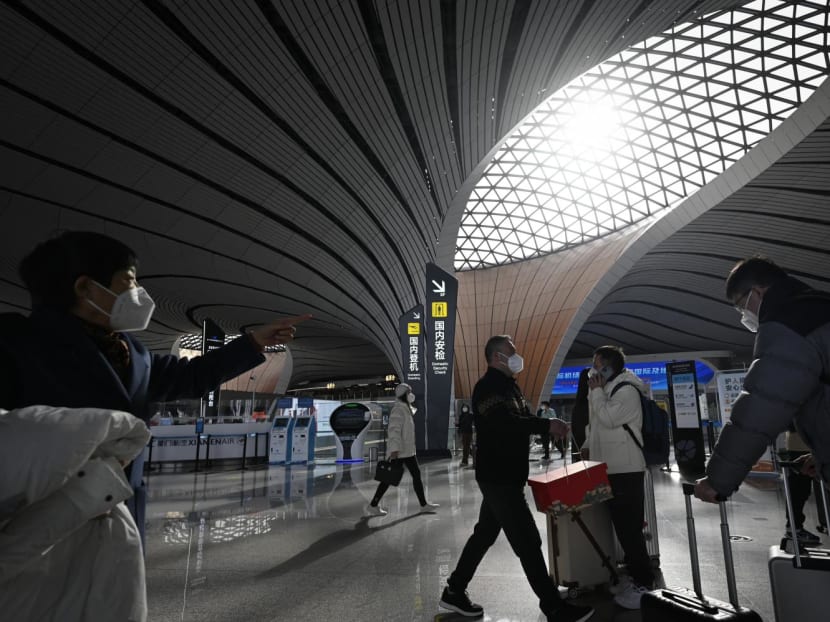 Passengers prepare to check in at Daxing International airport in Beijing on Jan 19, 2023.