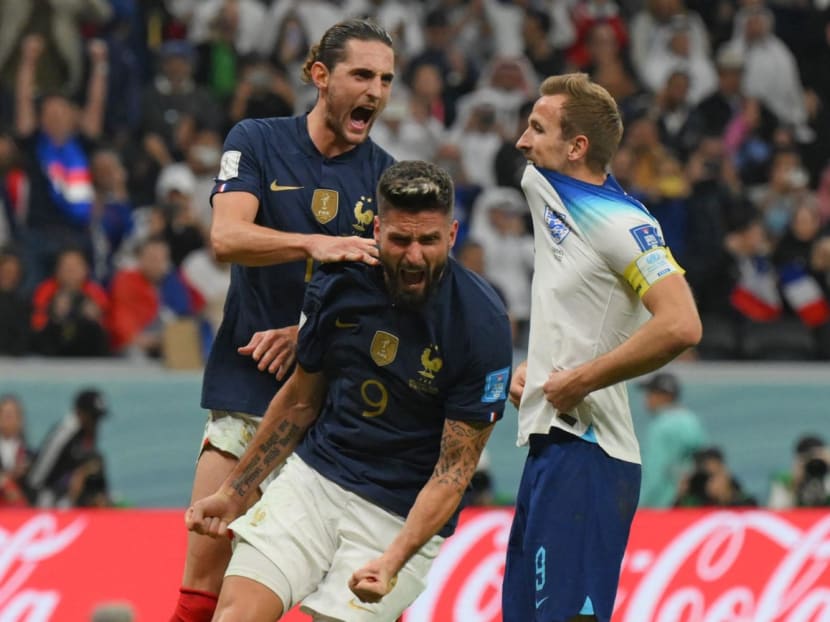 France's forward Olivier Giroud (centre) and France's defender Theo Hernandez (left) celebrating after England's forward Harry Kane (right) missed a second penalty kick during the Qatar 2022 World Cup quarter-final football match at the Al-Bayt Stadium in Al Khor, north of Doha, on Dec 10, 2022.